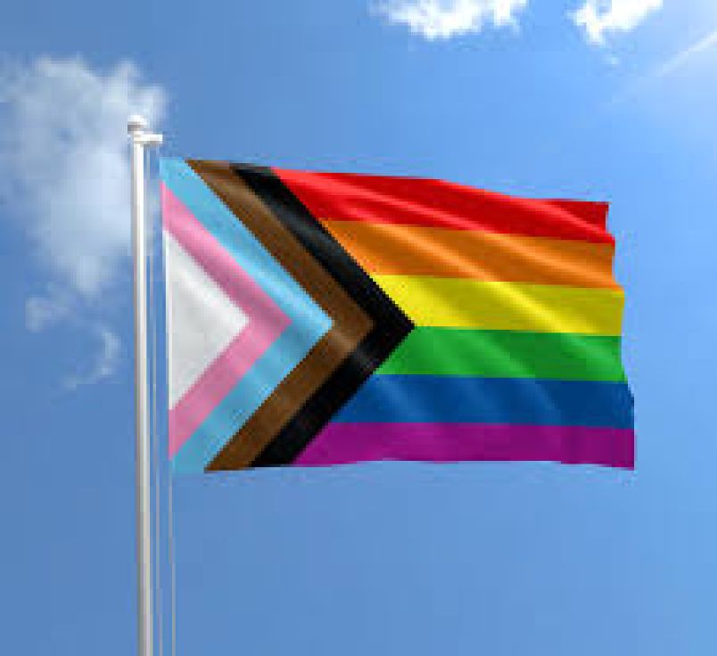progress pride flag with blue sky background